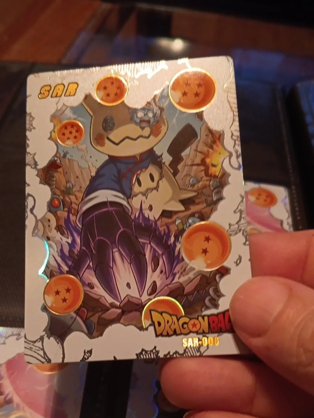 Pokemon Trading Card with Orange Dragon Ball Highlights